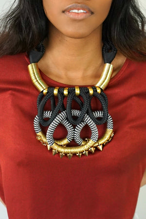 Close up of woman wearing the Gold Queen Crown necklace
