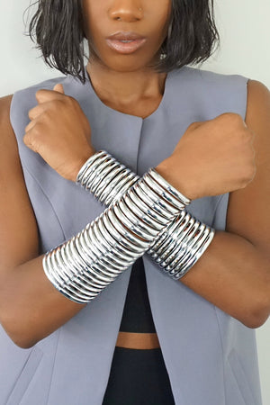 Close up of woman wearing Silver Gladiator Cuffs in "Wakanda Forever" pose