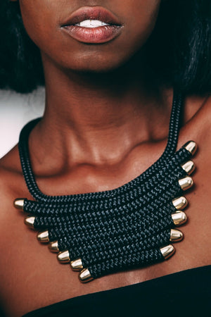 Close up of woman posing in The Fan necklace